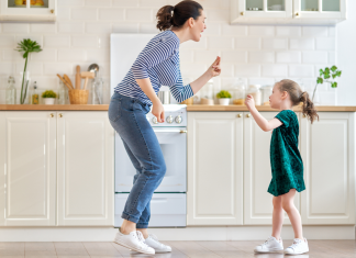 mom and daughter dancing in kitchen