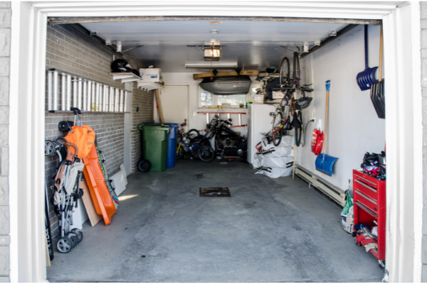a garage with belongings lining the walls in an organized way